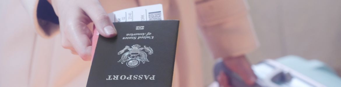 Girl with suitcase giving passport and boarding pass